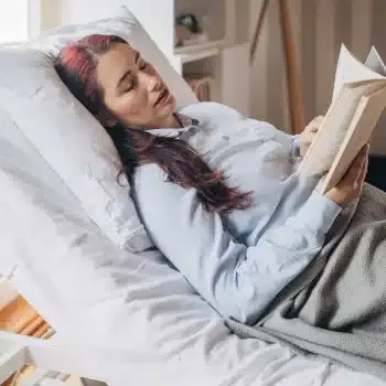 A woman resting comfortably in an adjustable bed