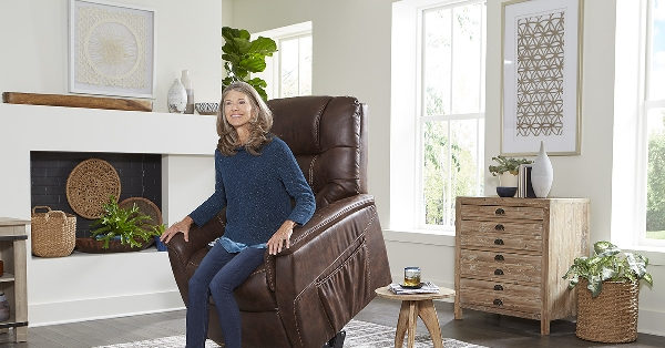 A woman sitting in a brown lift recliner in a living room