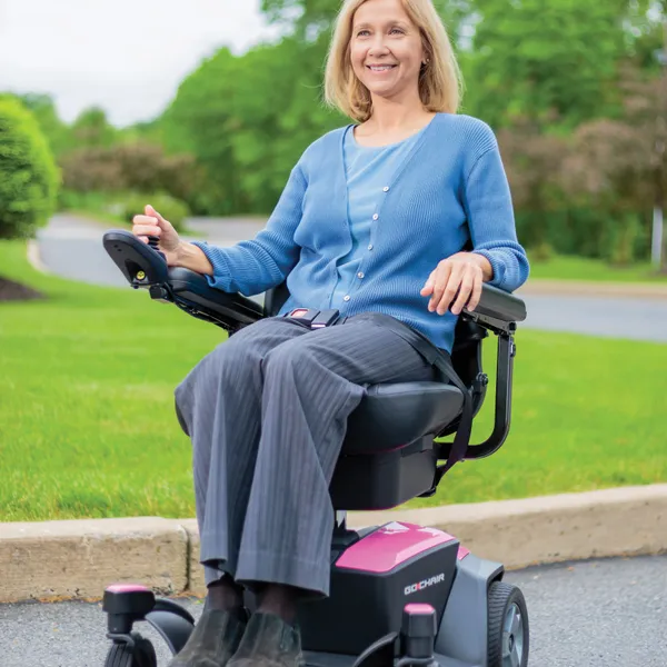 A woman using a power chair outdoors