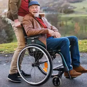 An older man enjoying time outdoors in a wheelchair